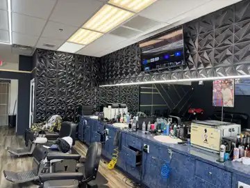 Barber styling stations and mirrors inside NFL Cuts Barbershop in Peoria, Arizona