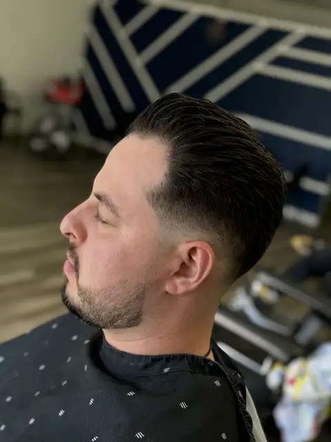 Sharp pompadour haircut styled at NFL Cuts Barbershop in Peoria, Arizona